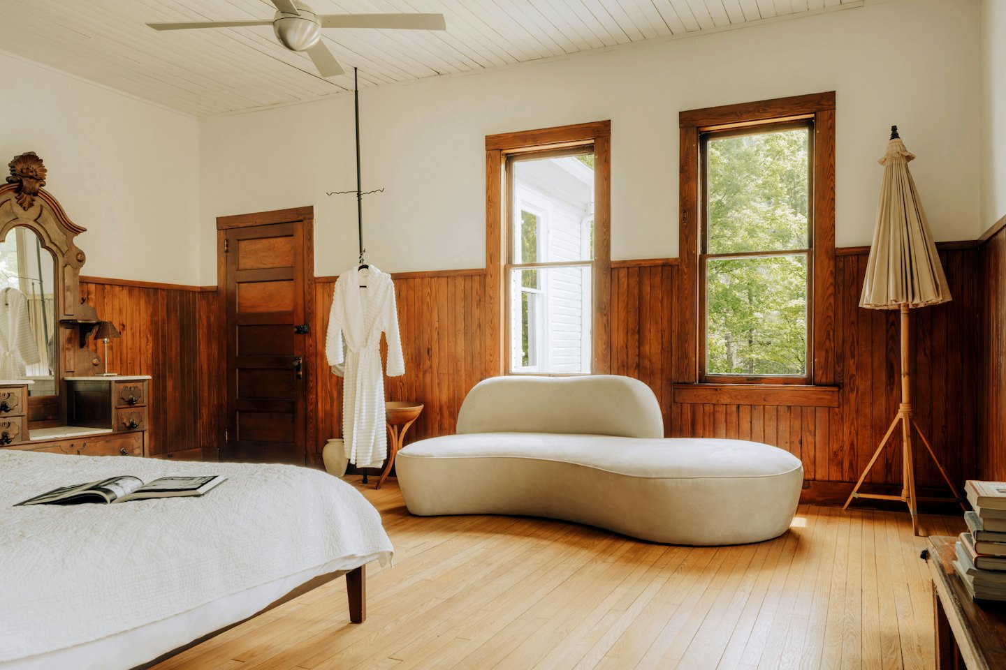 Comfortable bedroom with a large bed and chaise lounge.